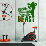 Motivational wall sticker 'Look like a Beauty, Train like a BEAST' in gym with exercise bike.
