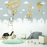 Charming animal wall stickers featuring penguins and foxes with hot air balloons in a child's room.
