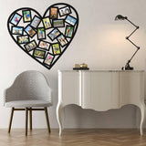 Heart-shaped collage photo decal on wall above stylish table and chair.