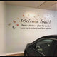 Vinyl lettering wall decal with butterflies saying 'Welcome home! There's always a place for you here' in a garage.