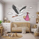 Stork delivering a baby girl nursery wall decal shown in a product video.