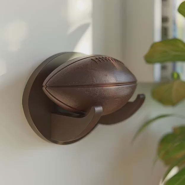 3D printed football wall display with curved mount shown in a product video.