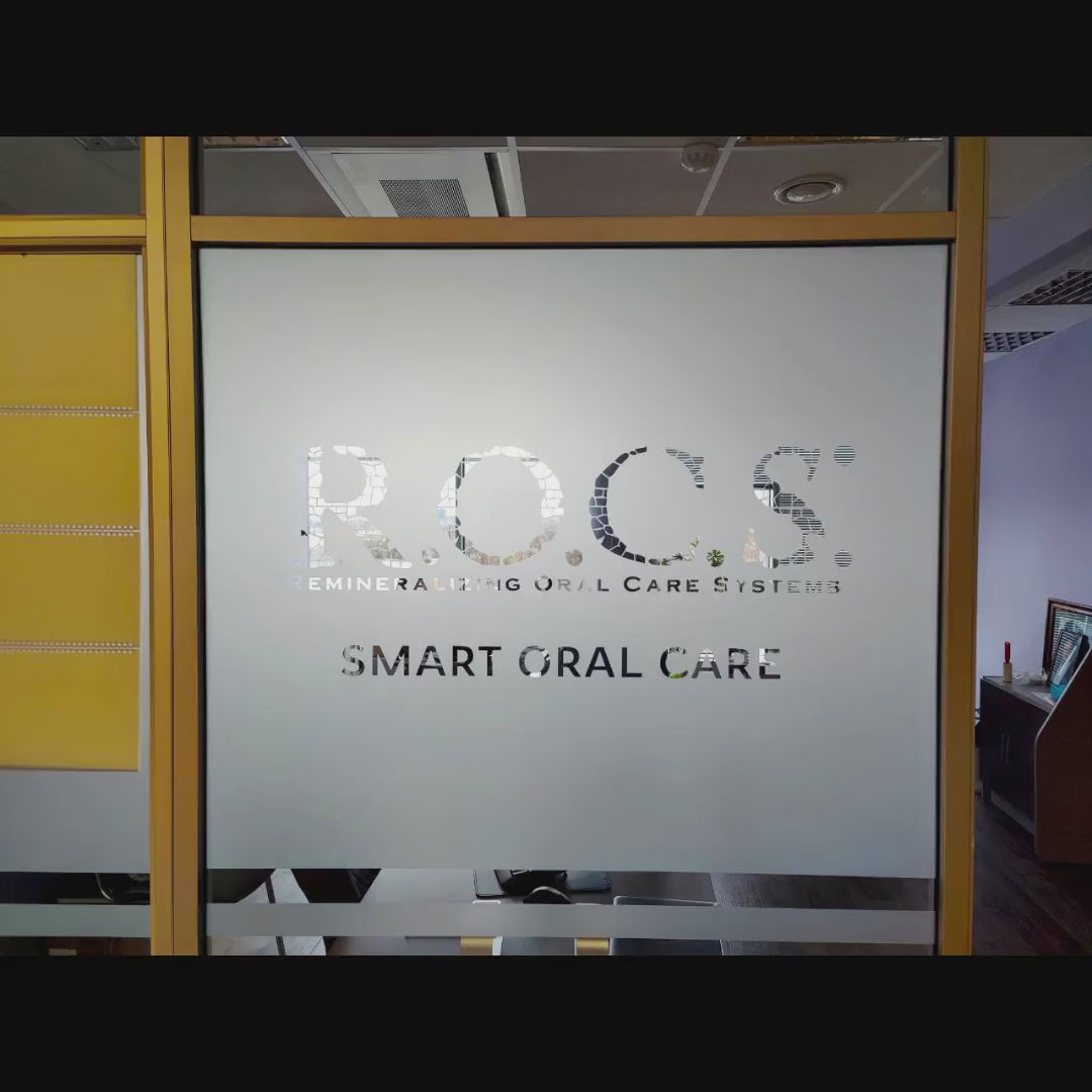 Custom frosted window film with printed logo shown on a glass door.