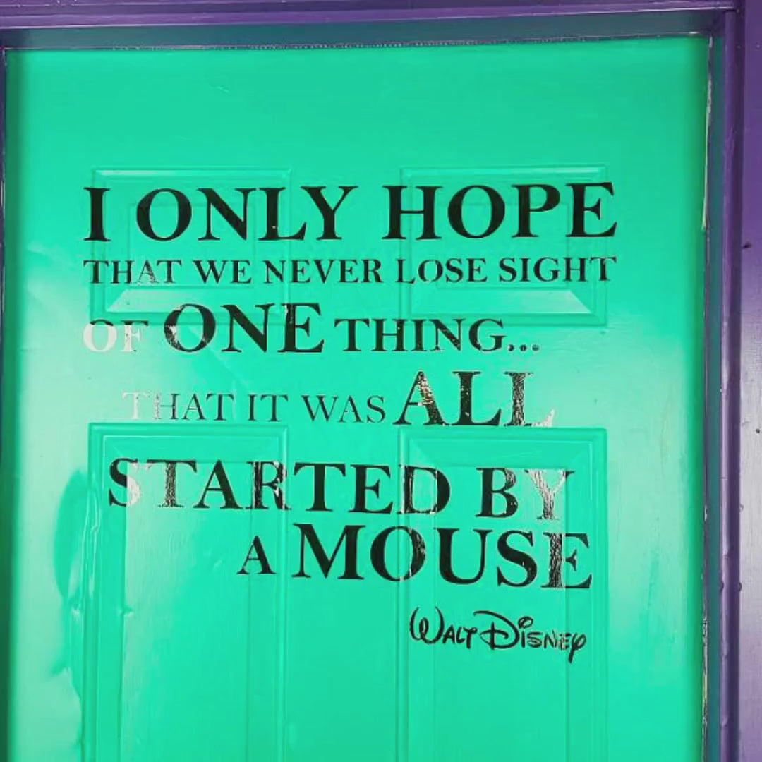 Inspirational quote wall decal displayed on a vibrant green door.