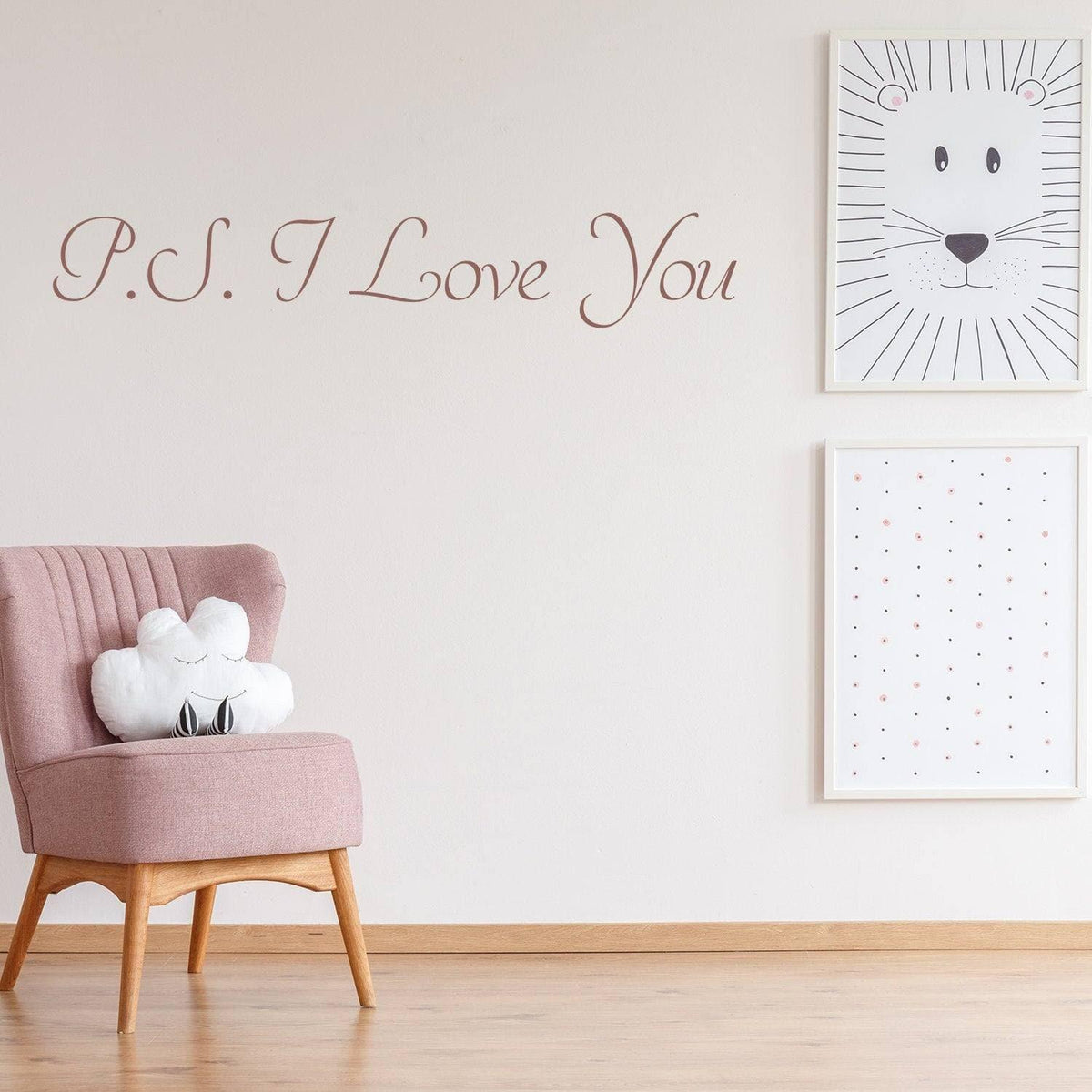 Romantic wall decal with 'P.S. I Love You' text above a pink chair and framed art.