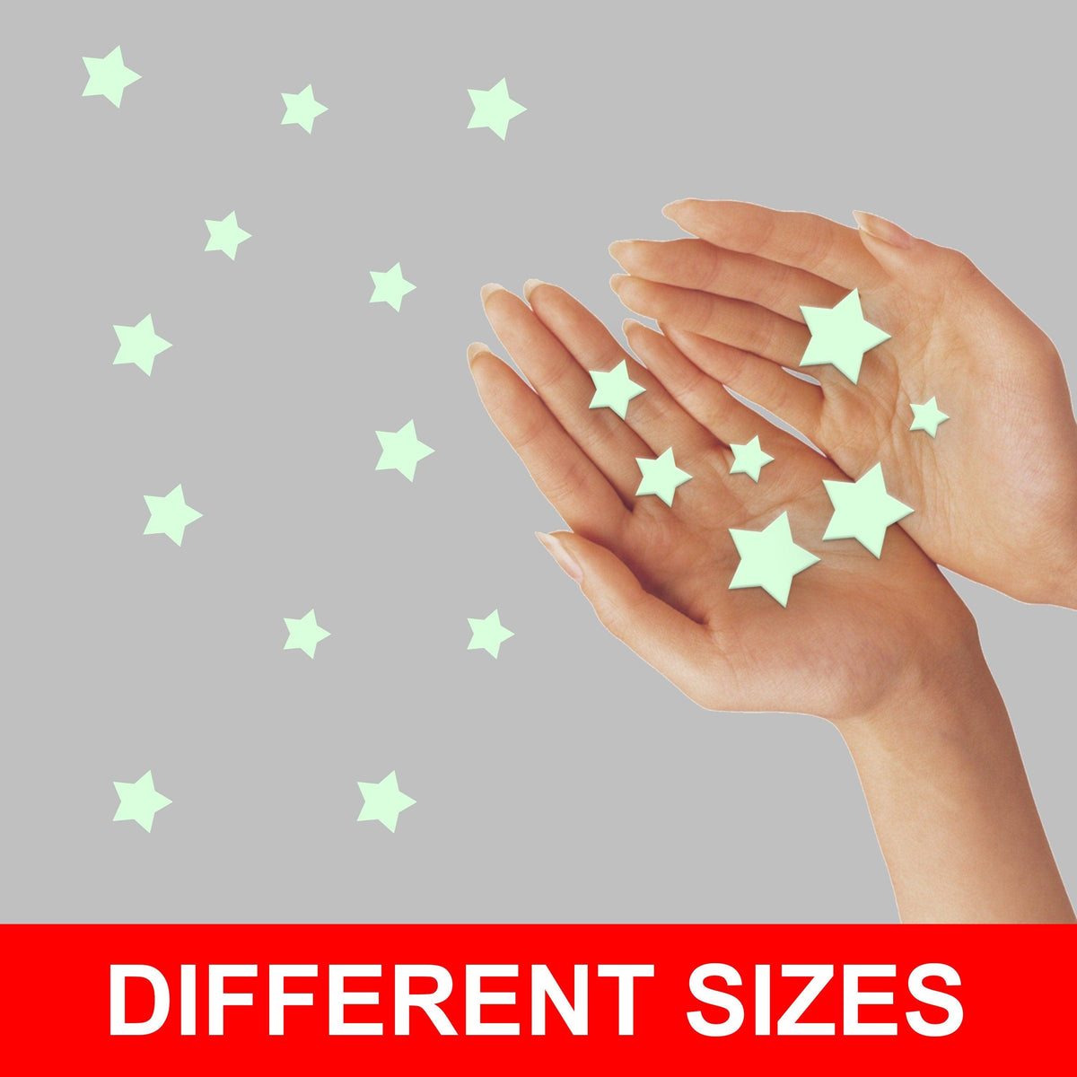 Hands showcasing various sizes of glow-in-the-dark star stickers for children's room decor.