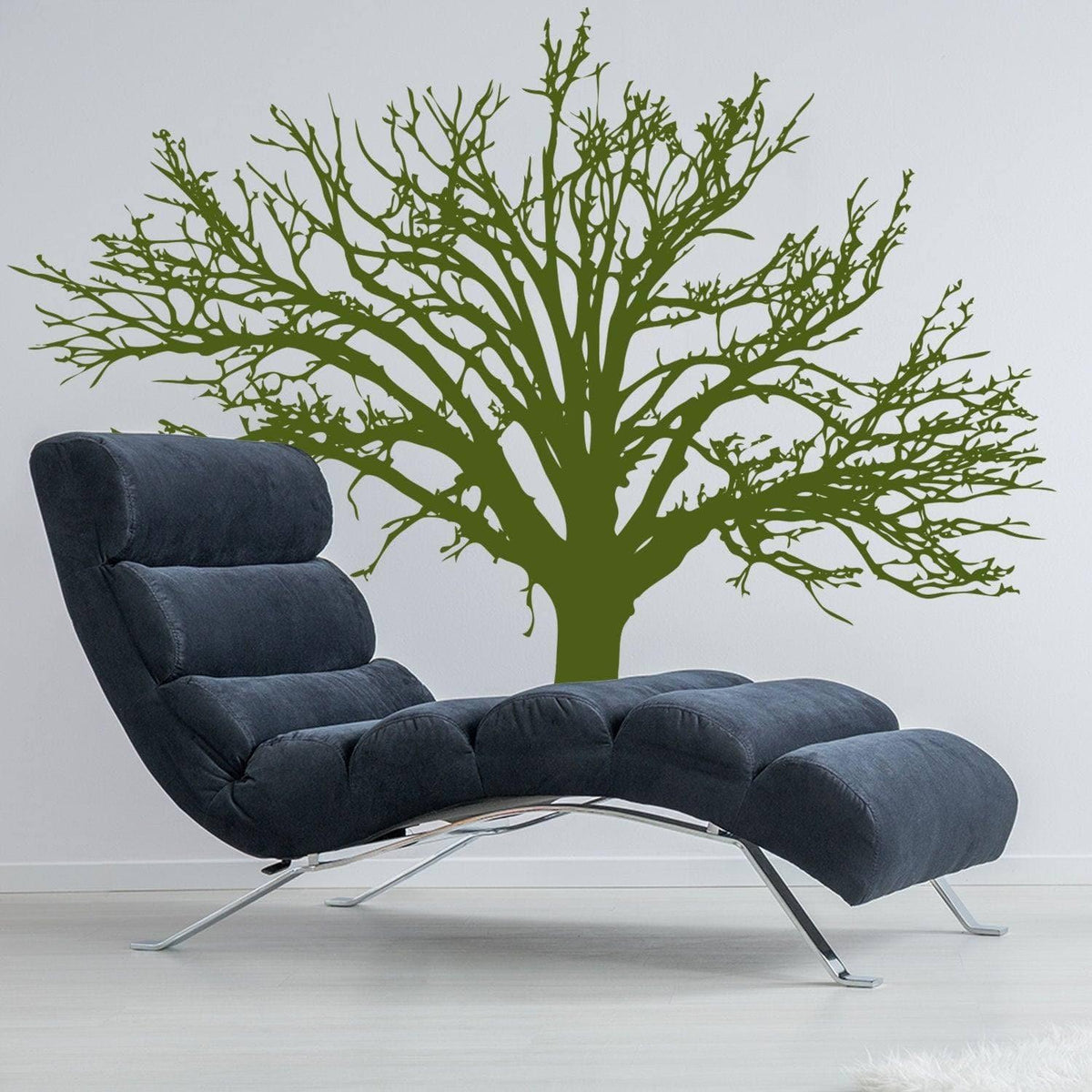 Stylish nature-inspired vinyl wall decal of a tree above a modern lounge chair.
