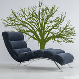 Stylish nature-inspired vinyl wall decal of a tree above a modern lounge chair.