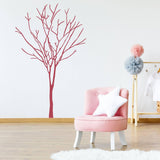 Vinyl wall decal of a tree design in a stylish room with pink chair and decor.