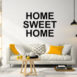 Home Sweet Home wall decal above a stylish couch, creating a warm and inviting living space.
