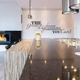Inspirational wall decal in modern kitchen, featuring motivational quote on smooth wall above stylish countertop.