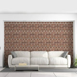 Stylish living room featuring 3D brick self-adhesive wallpaper behind a white sofa with cushions.