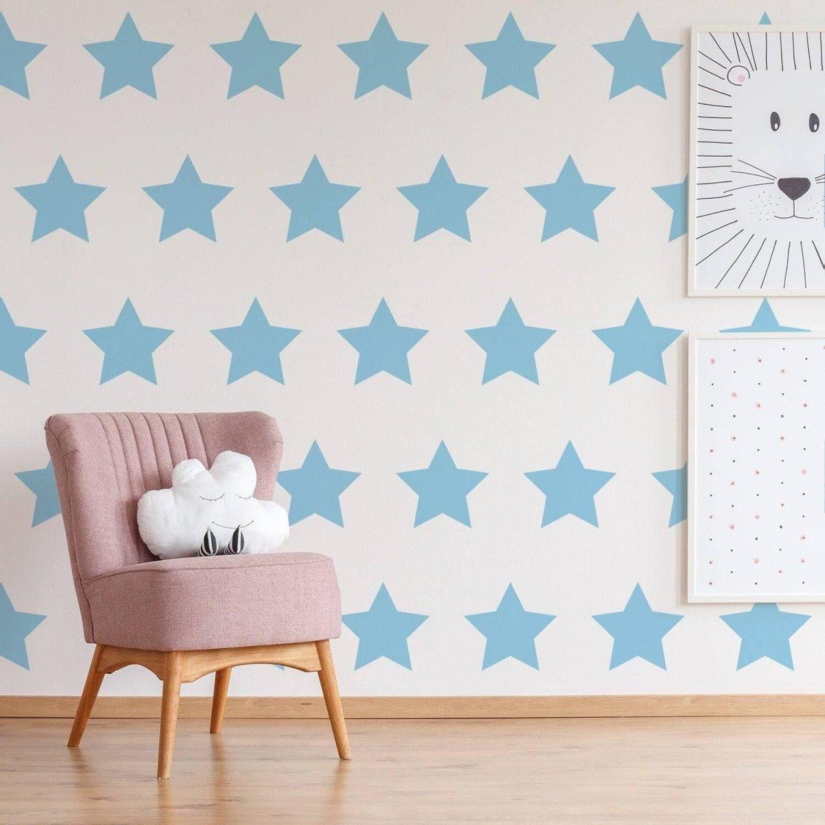 Charming baby room decor featuring blue star wall stickers and a cozy pink chair with a plush cloud pillow.