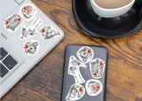Colorful anatomical stickers on a laptop and phone.