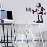 Street art robot vinyl decal applied on a modern workspace wall, featuring a barcode design.