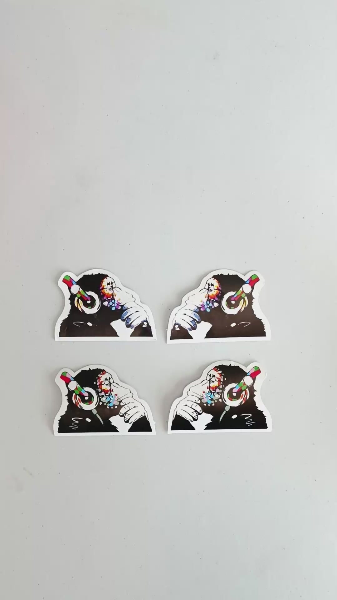 Set of four music-themed monkey vinyl stickers with headphones, perfect for laptop decoration.