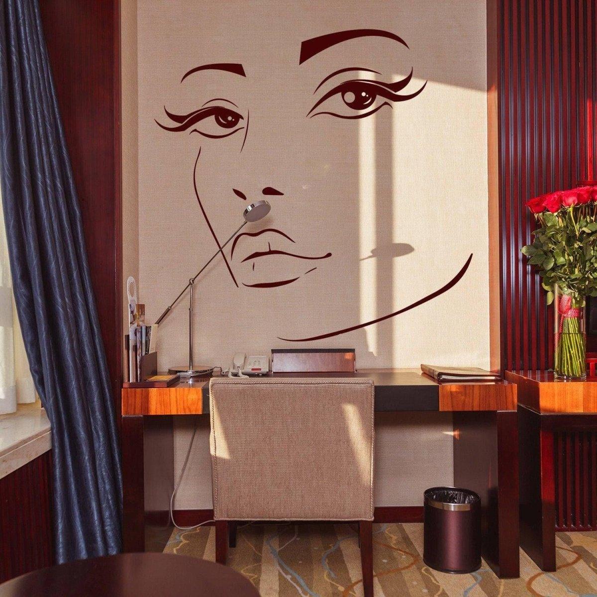 Charming woman face vinyl wall decal in elegant interior with desk and flowers.