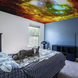 Celestial vinyl ceiling decal transforming a bedroom into a galaxy-themed oasis with colorful cosmic design.