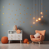 Stylish living room with orange star wall stickers, cozy chair, and modern decor.