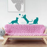 Adorable cat silhouette vinyl decal featuring playful cats on a pink knitted sofa.