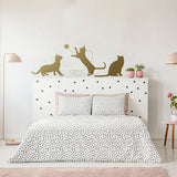 Adorable cat silhouette decal above a bed.