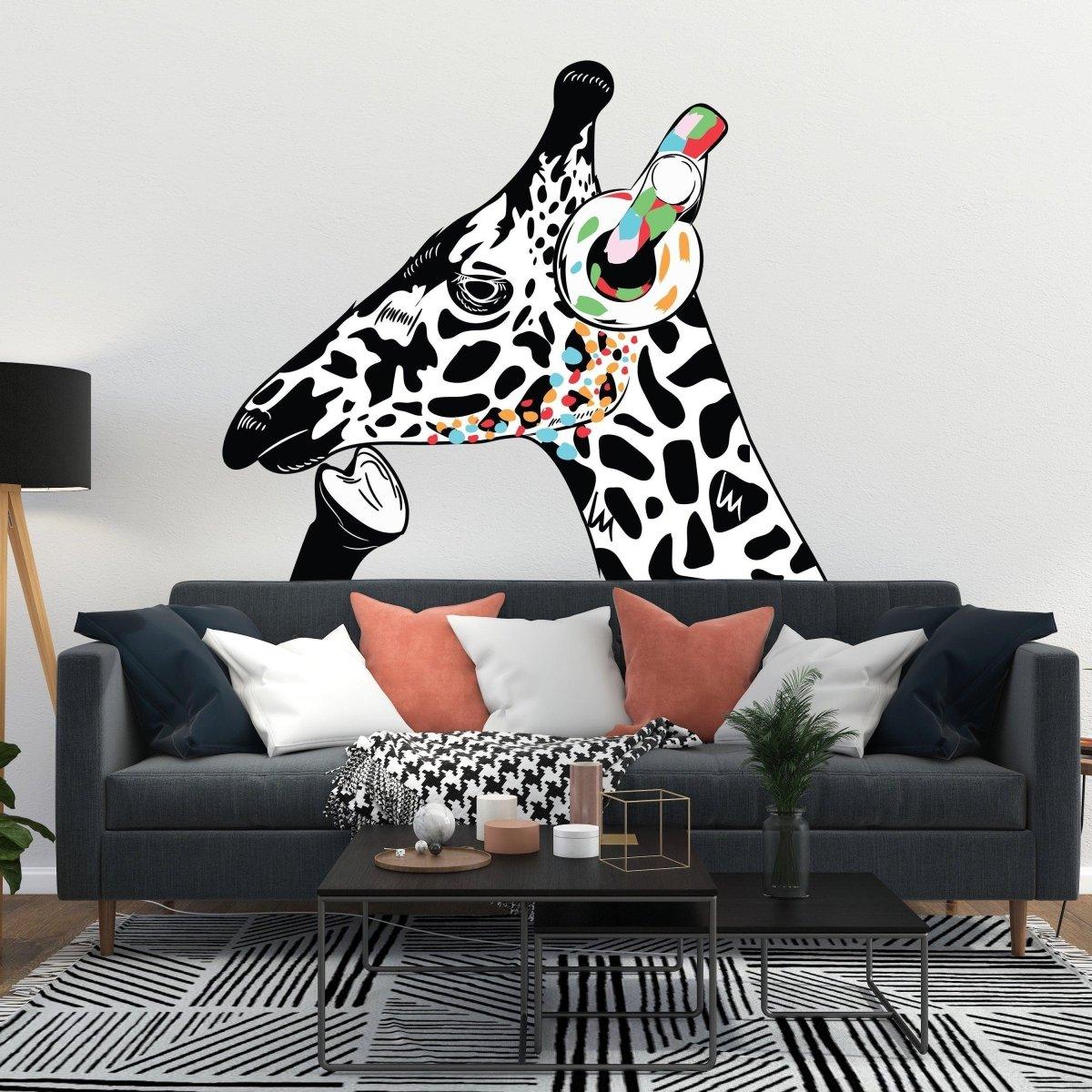 Contemplative giraffe wall sticker with colorful headphones on white wall above modern sofa.