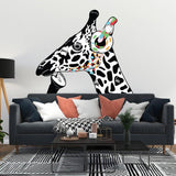 Contemplative giraffe wall sticker with colorful headphones on white wall above modern sofa.