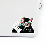 Contemplative monkey vinyl laptop decal with headphones, colorful design for personalizing computer devices.