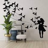 Artistic wall sticker of a girl surrounded by flying birds.