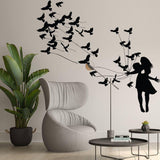 Wall sticker of a girl with birds, decorating a modern living room with a stylish chair and plant.