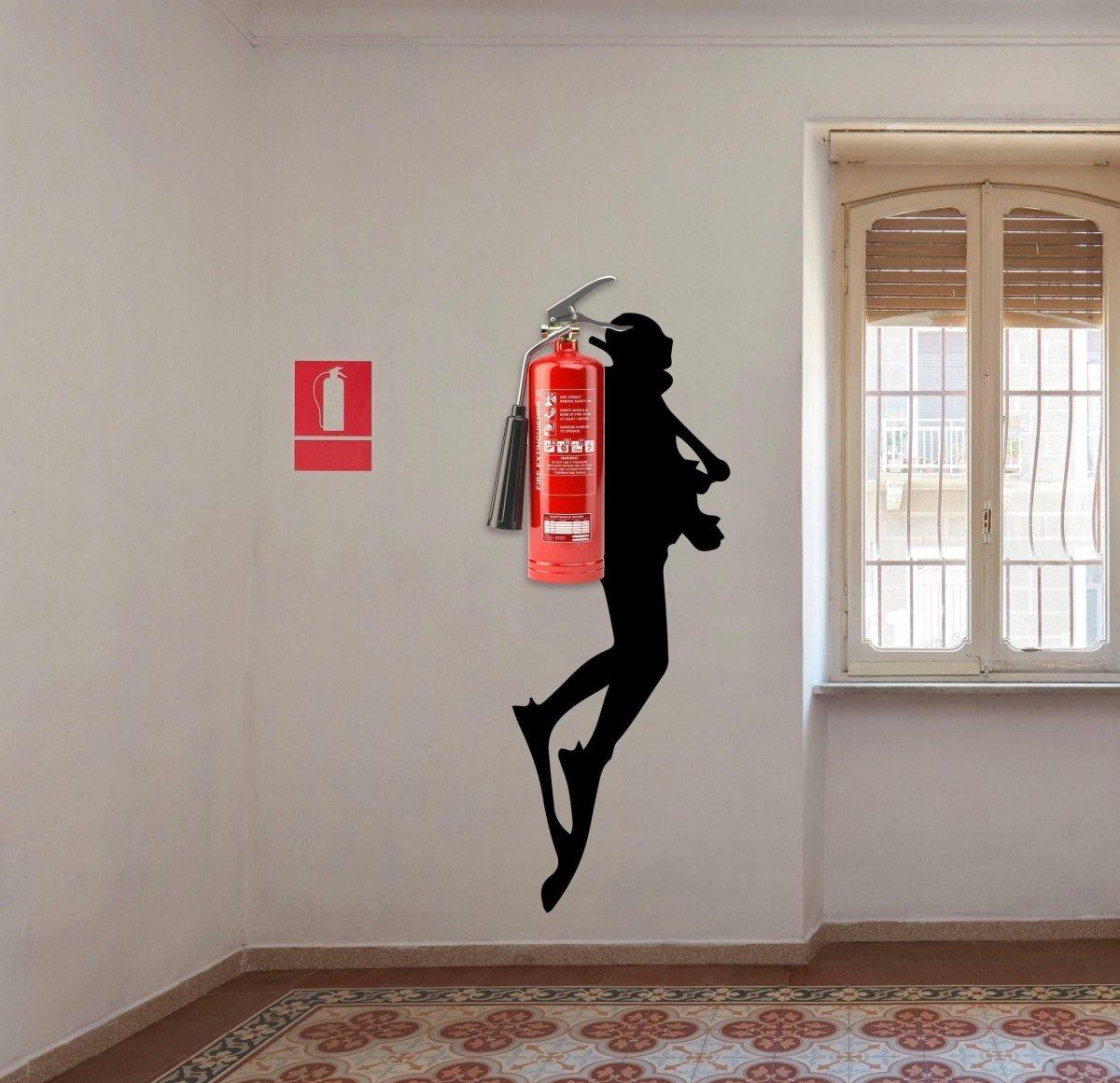 Scuba diver wall sticker with a fire extinguisher displayed in an interior.