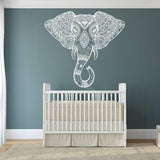 Whimsical elephant wall decal above a stylish crib, adding charm and elegance to a nursery decor.