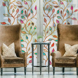 Elegant living room with leaf pattern privacy window film, stylish armchairs, and decorative table.