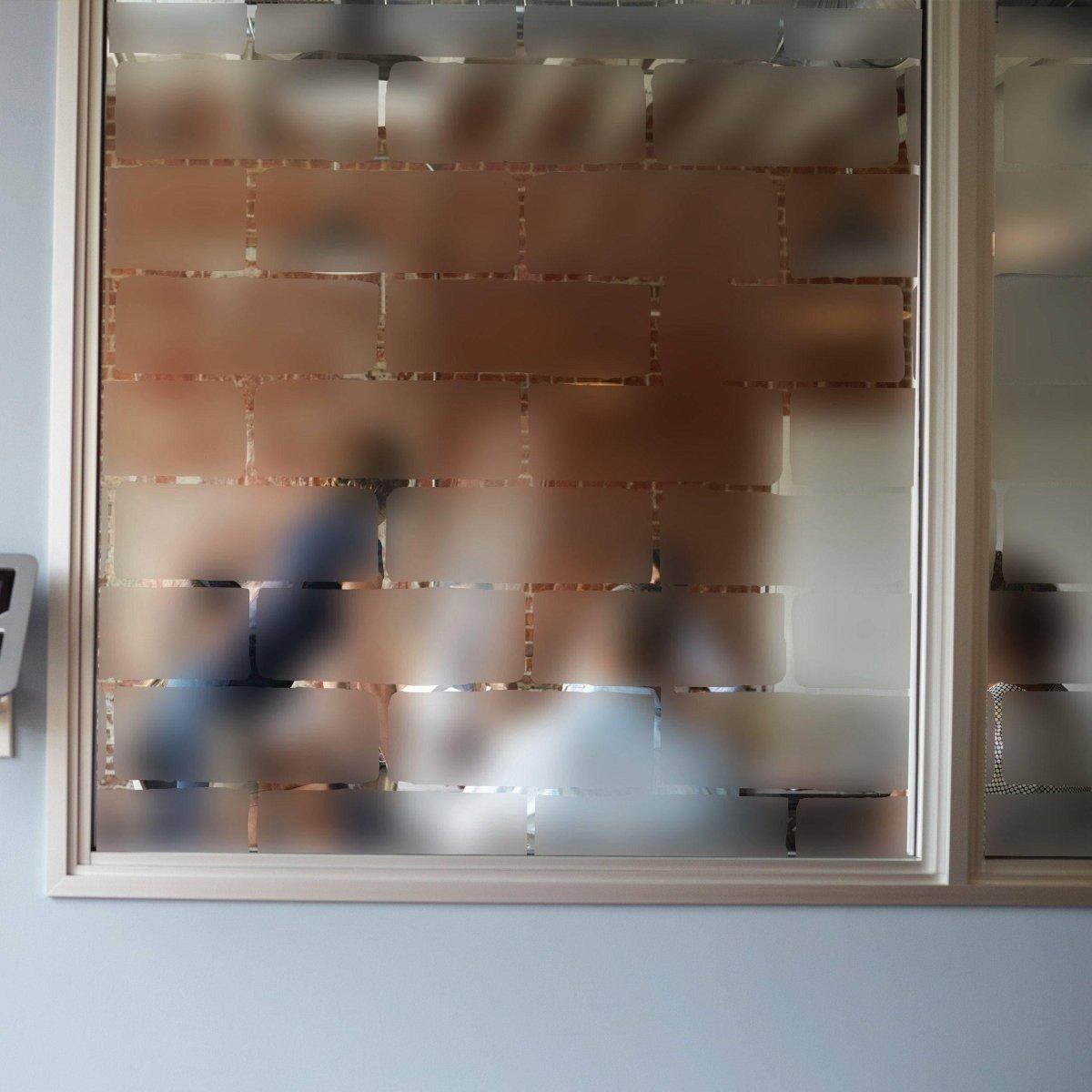Frosted window film decal providing privacy while allowing natural light to shine through.