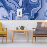 Stylish living room with a marble wall mural, modern furnishings, and artistic decor.