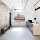 Elegant workspace with wall decal showcasing company name and keywords for office decor enhancement.