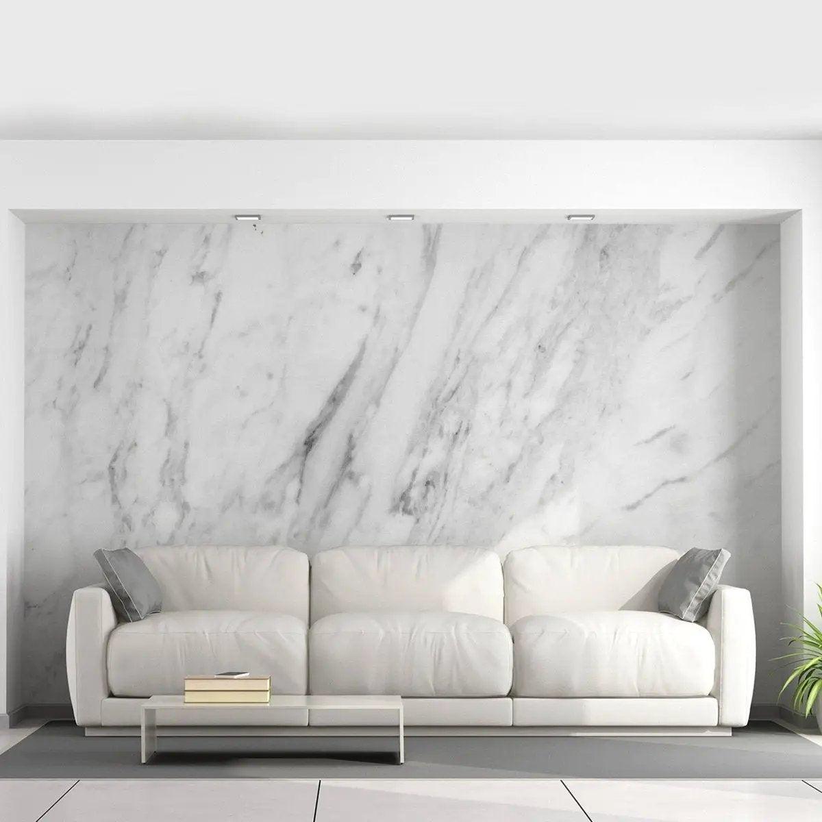 Stylish living room featuring stone-pattern adhesive wallpaper and a modern white couch with decorative pillows.