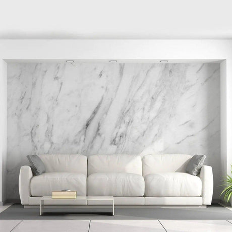 Stylish living room featuring stone-pattern adhesive wallpaper and a modern white couch with decorative pillows.