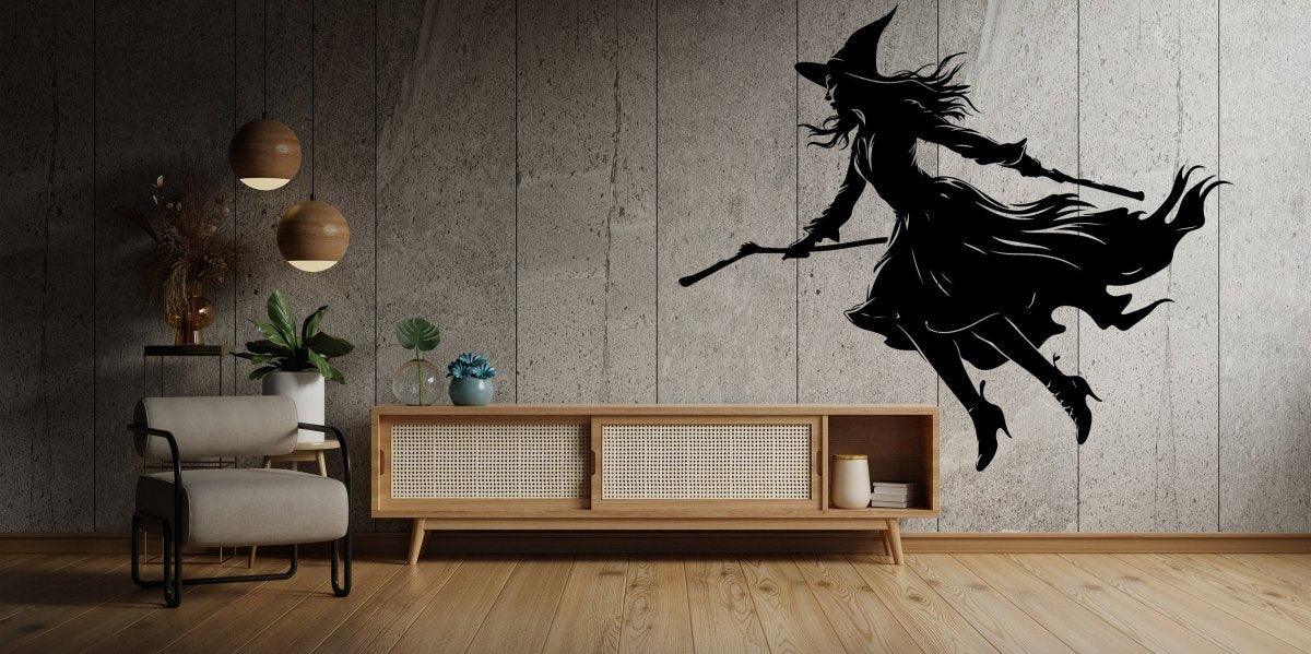 Flying broom figure silhouette wall decal displayed on a modern wall.
