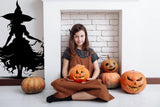 Stylized figure and flame silhouette wall decal shown in a room setting.