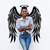 Smiling woman with angel wings wall sticker, showcasing the Majestic Feather Wall Sticker for magical home decor.