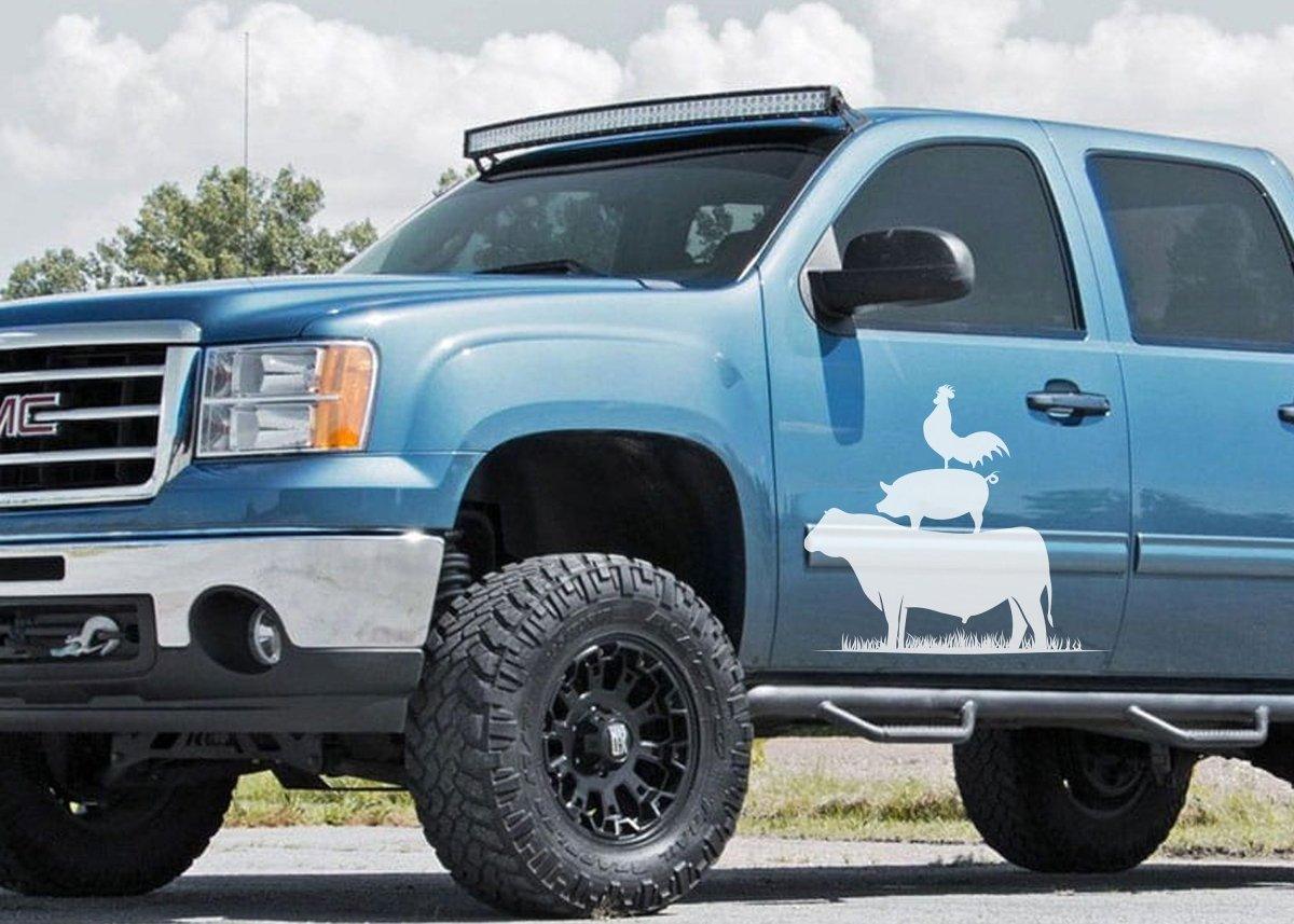 Blue truck with a fun farm animal decal featuring a cow and a chicken on the side.