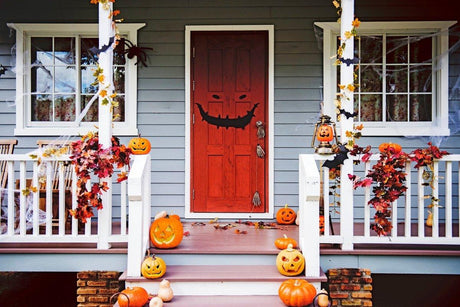 Graphic grinning face door decal displayed at a home entrance.