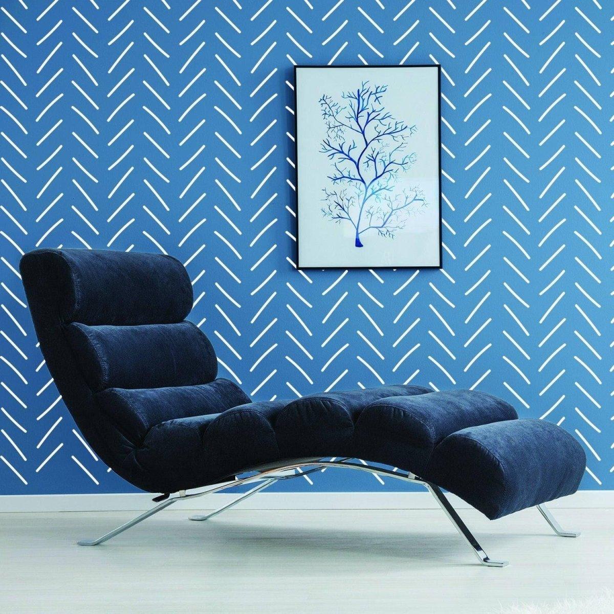 Stylish living room featuring herringbone wall stickers, modern blue chair, and framed art on wall.