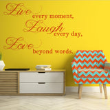 Live Laugh Love wall art on a yellow wall with colorful chair and modern furniture.