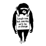 Monkey wall sticker holding a Laugh Now quote sign.
