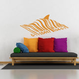 Barcode shark wall sticker displayed above colorful pillows.