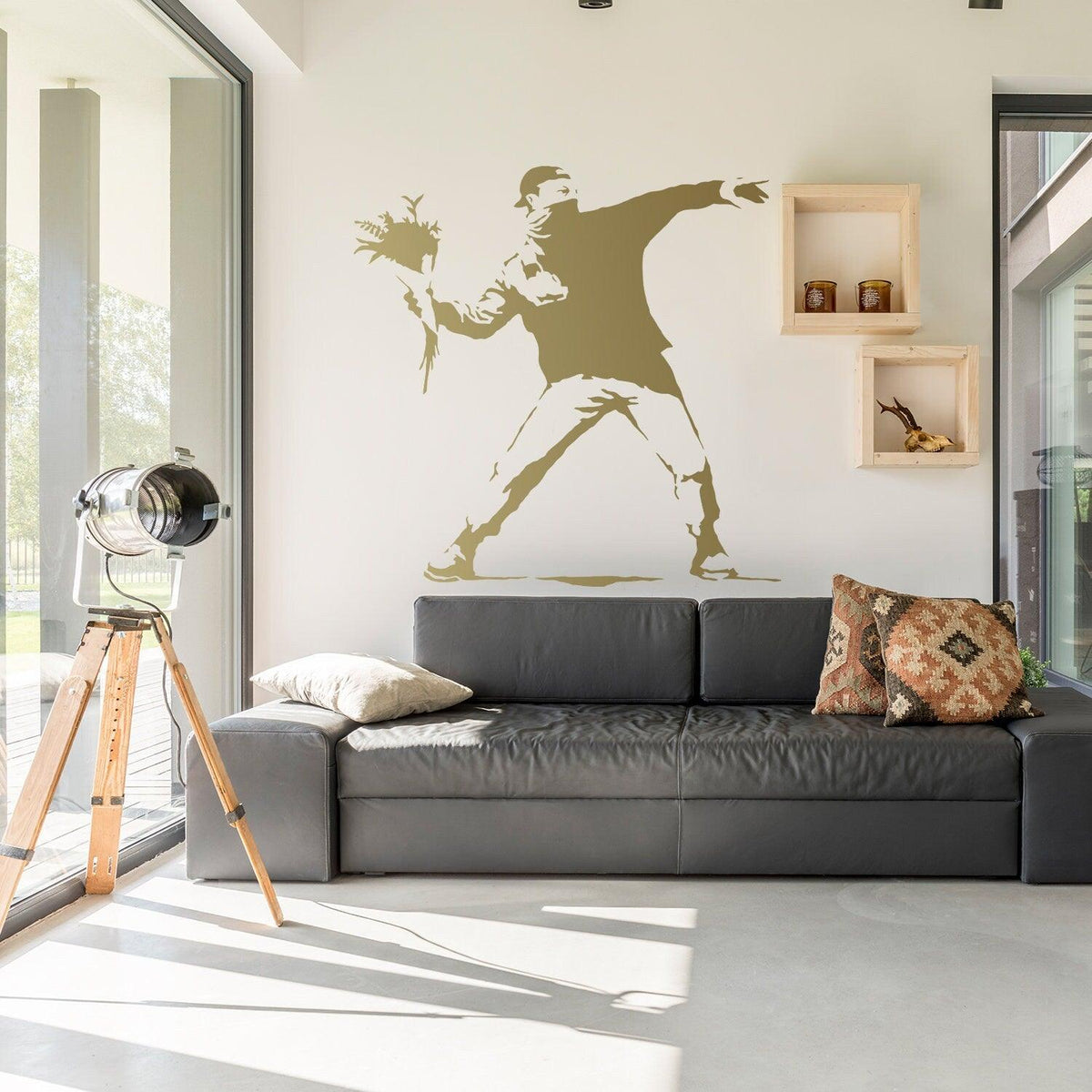 Flower thrower girl wall sticker displayed above a black couch.
