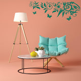 Cozy living room setup featuring a turquoise chair, marble table, and decorative butterfly wall decals.