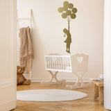 Balloon girl wall sticker displayed in a nursery with a crib.